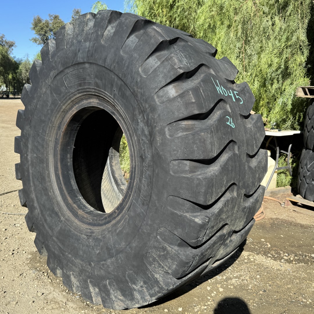 <font color='#da2127' font size ='2'><b>26.5X25 Advance OTR Tire E-3 L-3 Rock Regular 20-Ply </font></b><br><font size ='1' color='grey'>CONDITION: </font><font size ='2'>Used<br><font size ='1' color='grey'>TREAD DEPTH:</font><font size ='2'> 26/32nds<br><font size ='1' color='grey'>DETAILS:</font><font size ='2'> Clean, Mildly Aged Tread<br><font size ='1' color='grey'>REF #:</font><font size ='2'> W045<br><font size ='1' color='grey'>LOCATION:</font><font size ='2'> San Jacinto, CA