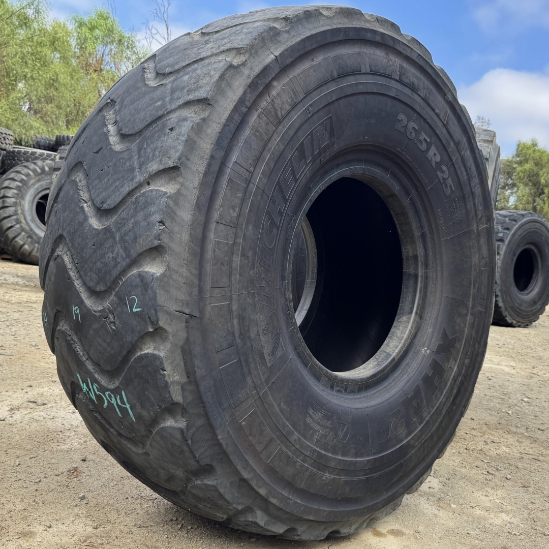 <font color='#da2127' font size ='2'><b>26.5R25 Michelin OTR Tire E-3 L-3 XHA2 2-Star </font></b><br><font size ='1' color='grey'>CONDITION: </font><font size ='2'>Used<br><font size ='1' color='grey'>TREAD DEPTH:</font><font size ='2'> 15/32nds<br><font size ='1' color='grey'>DETAILS:</font><font size ='2'> Clean, Minor Rock Cuts on One Sidewall<br><font size ='1' color='grey'>REF #:</font><font size ='2'> W594<br><font size ='1' color='grey'>LOCATION:</font><font size ='2'> San Jacinto, CA